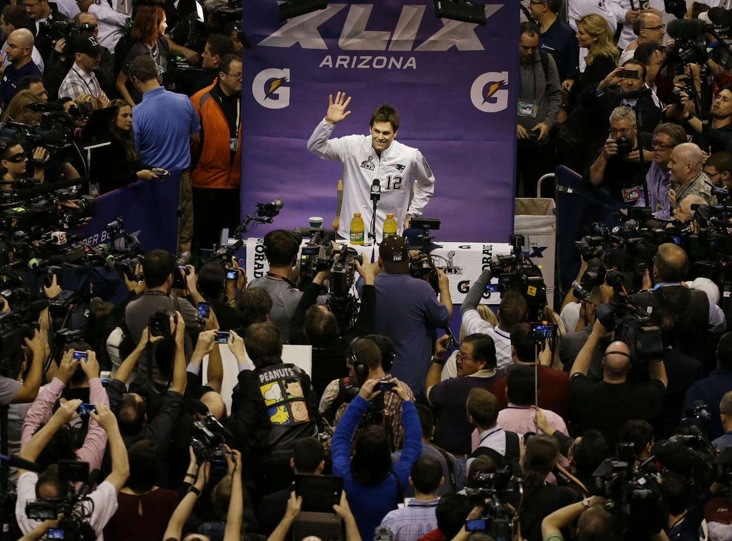 New England Patriots' Tom Brady waves during media day for NFL Super Bowl XLIX football game Tuesday, Jan. 27, 2015, in Phoenix. (AP Photo/Charlie Riedel) ORG XMIT: MIN2015012717030280