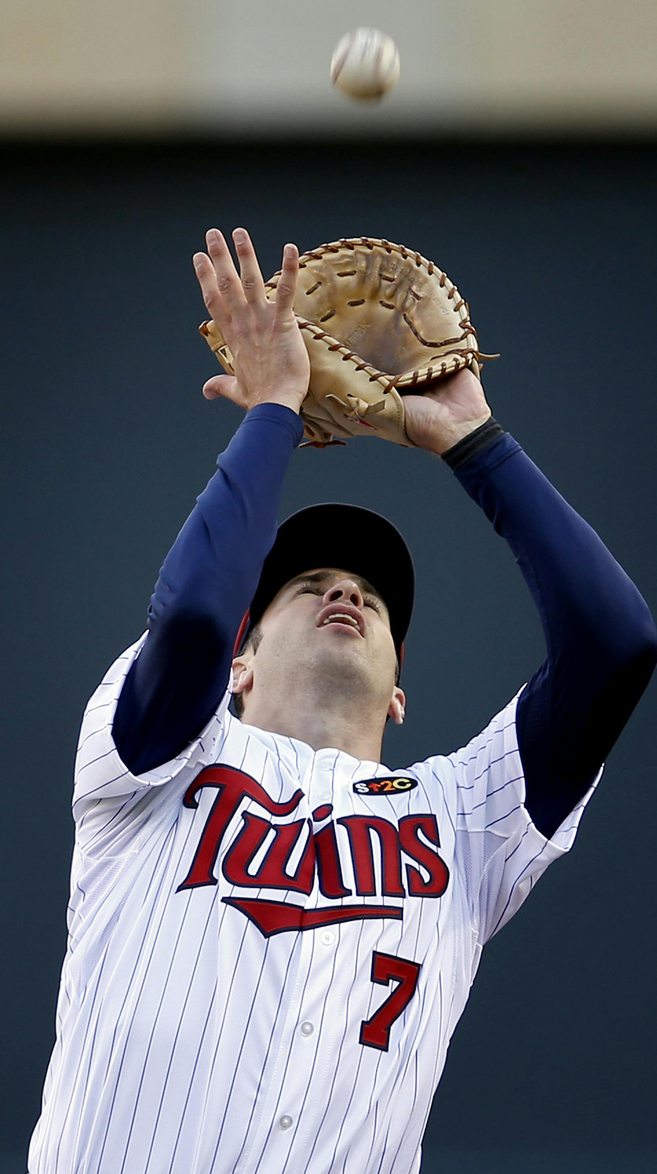 Twins first baseman Joe Mauer caught a pop up hit by Yoenis Cespedes (52) in the fifth inning. ] CARLOS GONZALEZ cgonzalez@startribune.com - April 7, 2014, Minneapolis, Minn., Target Field, MLB, Minnesota Twins vs. Oakland A‚Äôs ‚Äì Twins home opener