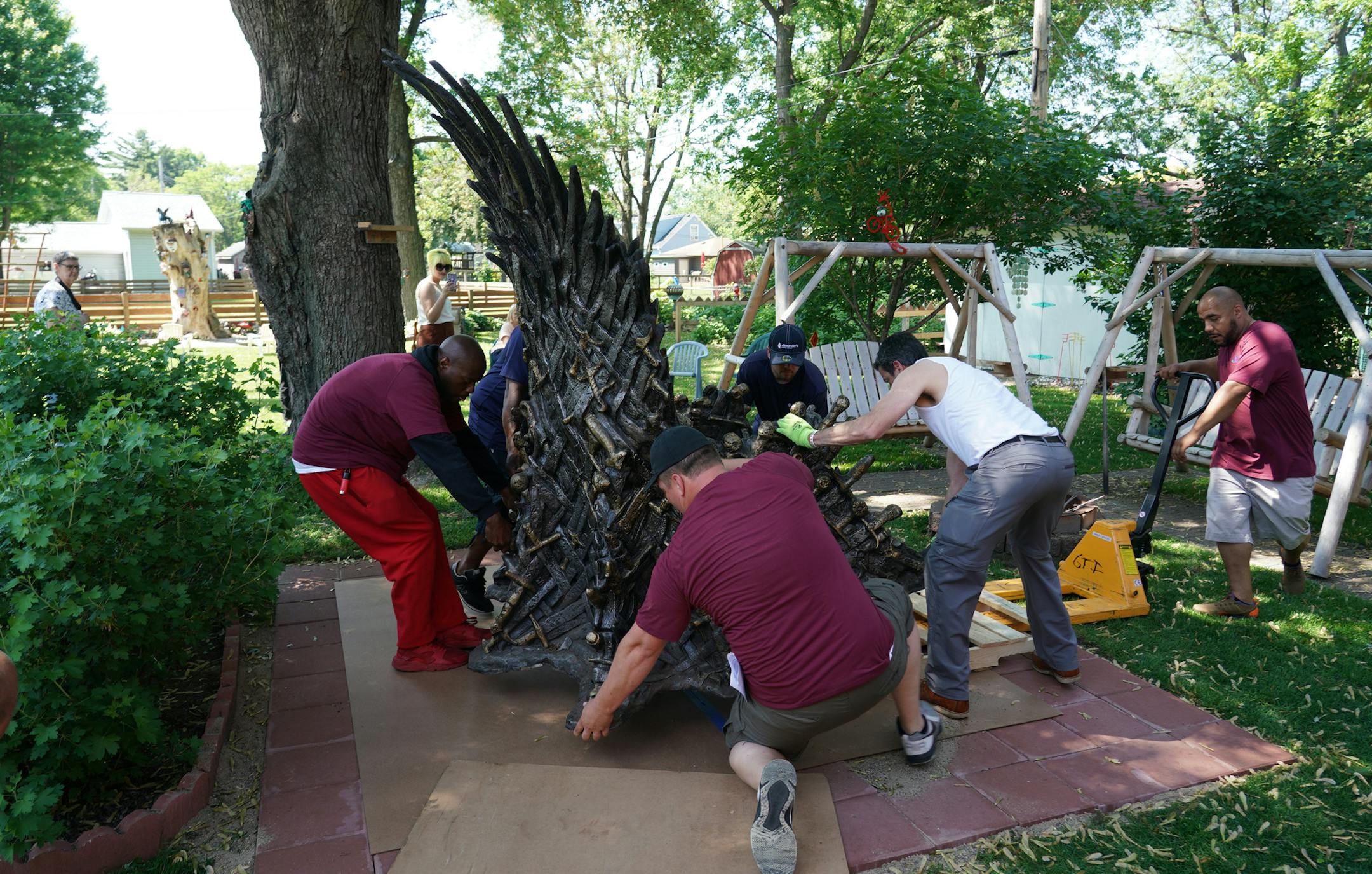 Ken and Gail James, a retired couple who live in Richfield, entered a national contest and won their own life-sized replica version of the Iron Throne from the HBO show, Game of Thrones. Here, moving crews set the Iron Throan in place near Ken and Gail&#x2019;s backyard firepit. ]
brian.peterson@startribune.com
Richfield, MN Tuesday, June 4, 2019