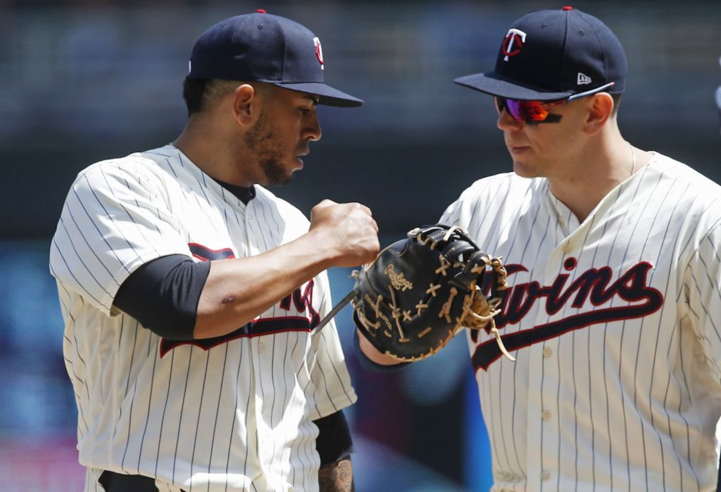 Minnesota Twins pitcher Fernando Romero, left, making his major league debut, is congratulated by first baseman Logan Morrison before being lifted in the sixth inning in of a baseball game against the Toronto Blue Jays Wednesday, May 2, 2018, in Minneapolis. Romero picked up the win in the Twins' 4-0 victory.