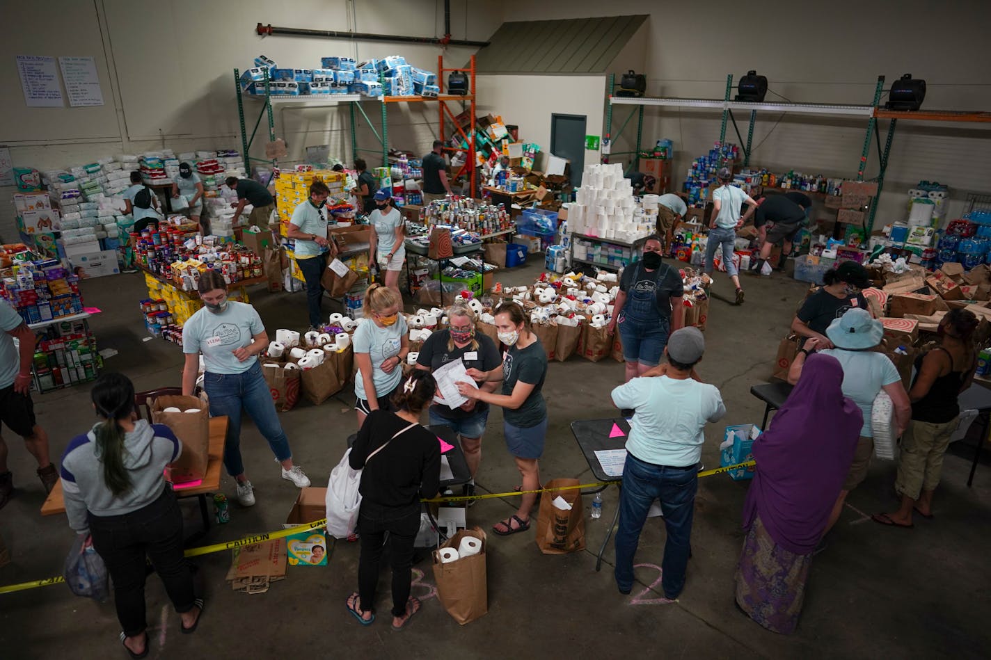 Clients picked up base bags of essentials as well as other items in the distribution center in a repurposed warehouse at Du Nord Craft Spirits Wednesday afternoon.