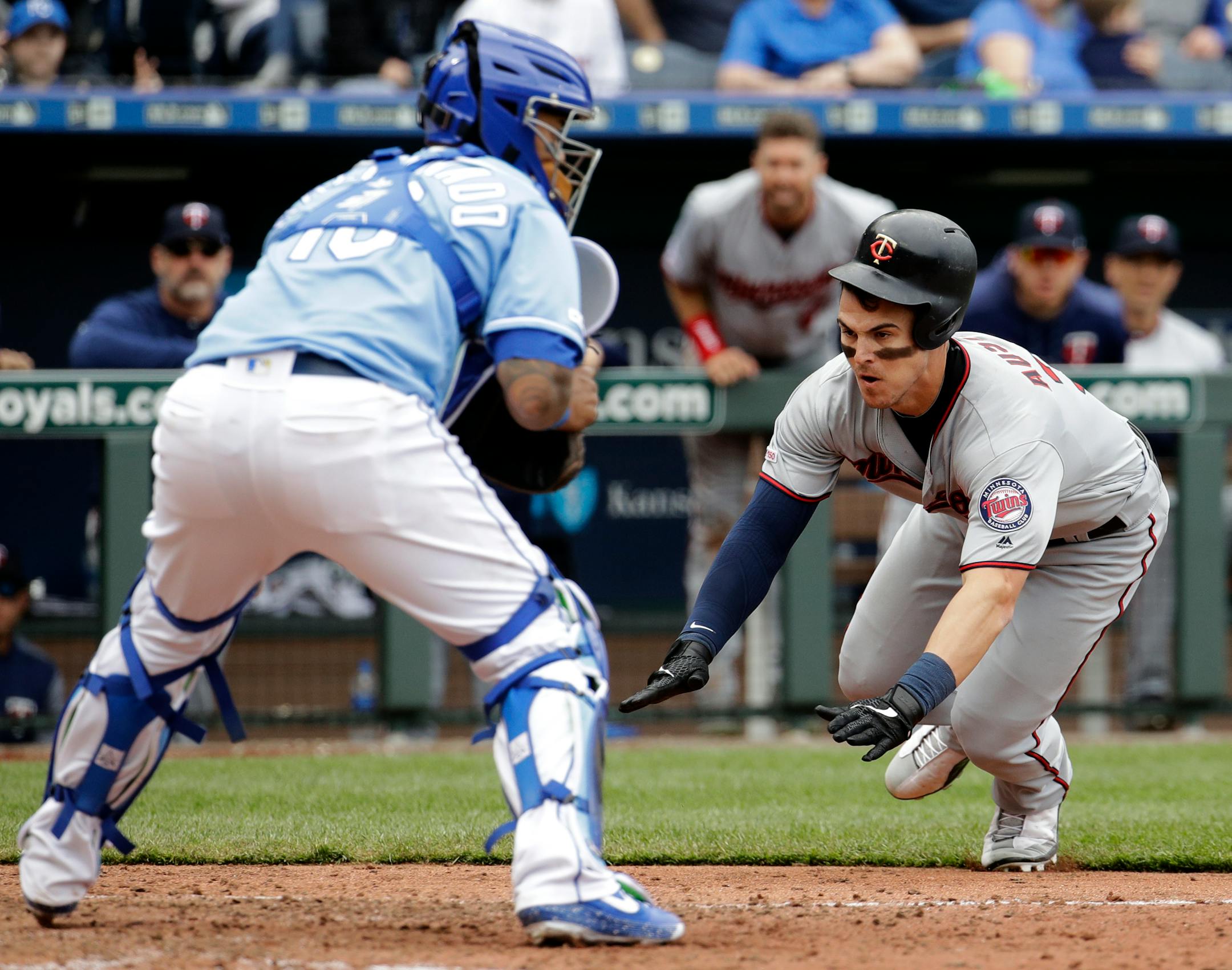 The Twins' Tyler Austin beats the tag at home by Royals catcher Martin Maldonado to score on a single by Max Kepler during the eighth inning