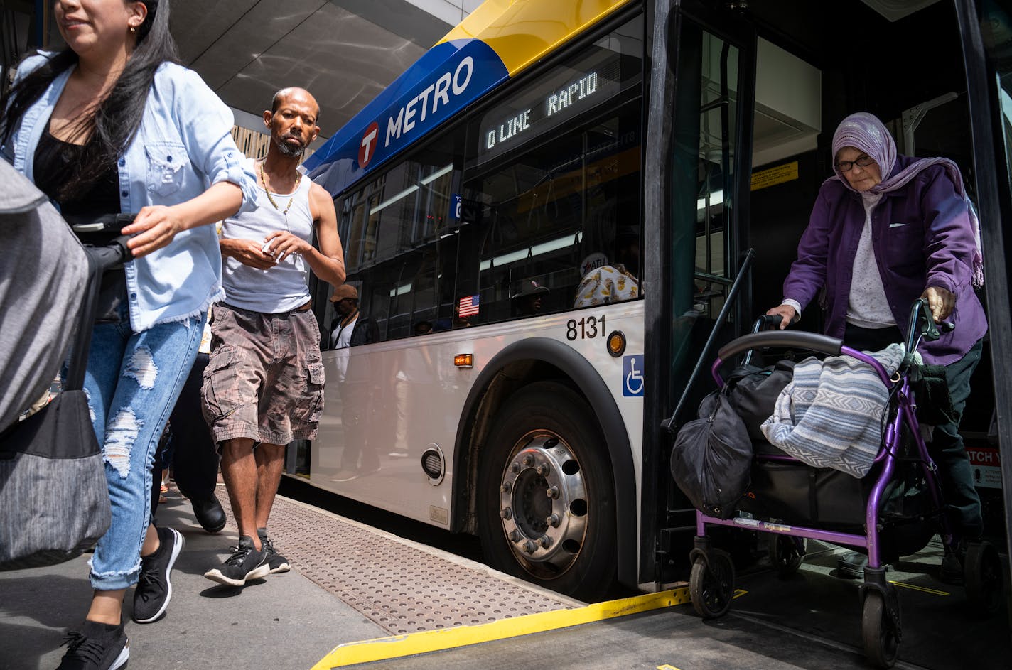 People getting off bus in downtown Minneapolis.