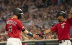Marwin Gonzalez, back in the Twins lineup after missing nearly three weeks, was congratulated by Eddie Rosario after he scored on a Nelson Cruz single