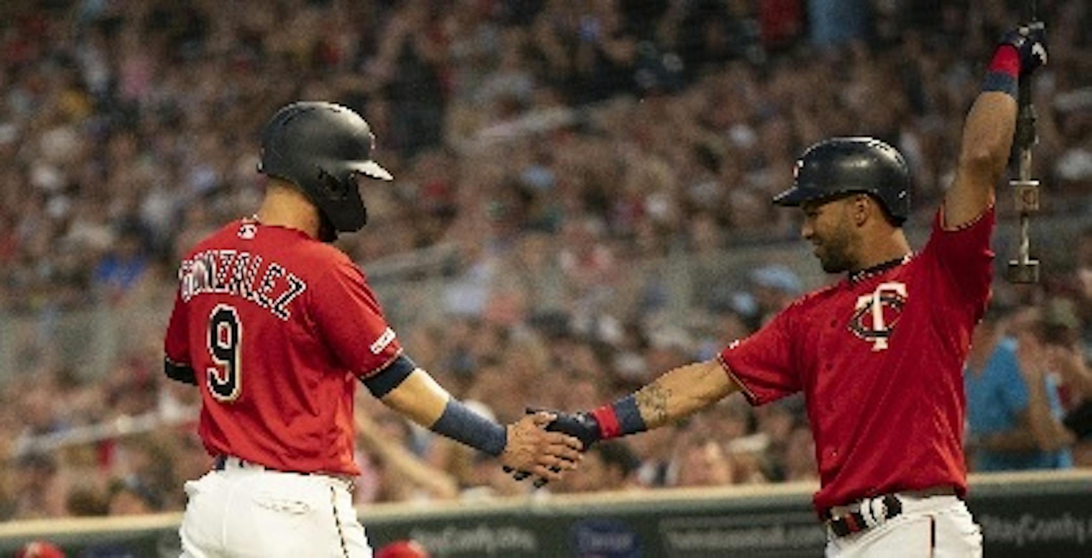 Marwin Gonzalez, back in the Twins lineup after missing nearly three weeks, was congratulated by Eddie Rosario after he scored on a Nelson Cruz single.