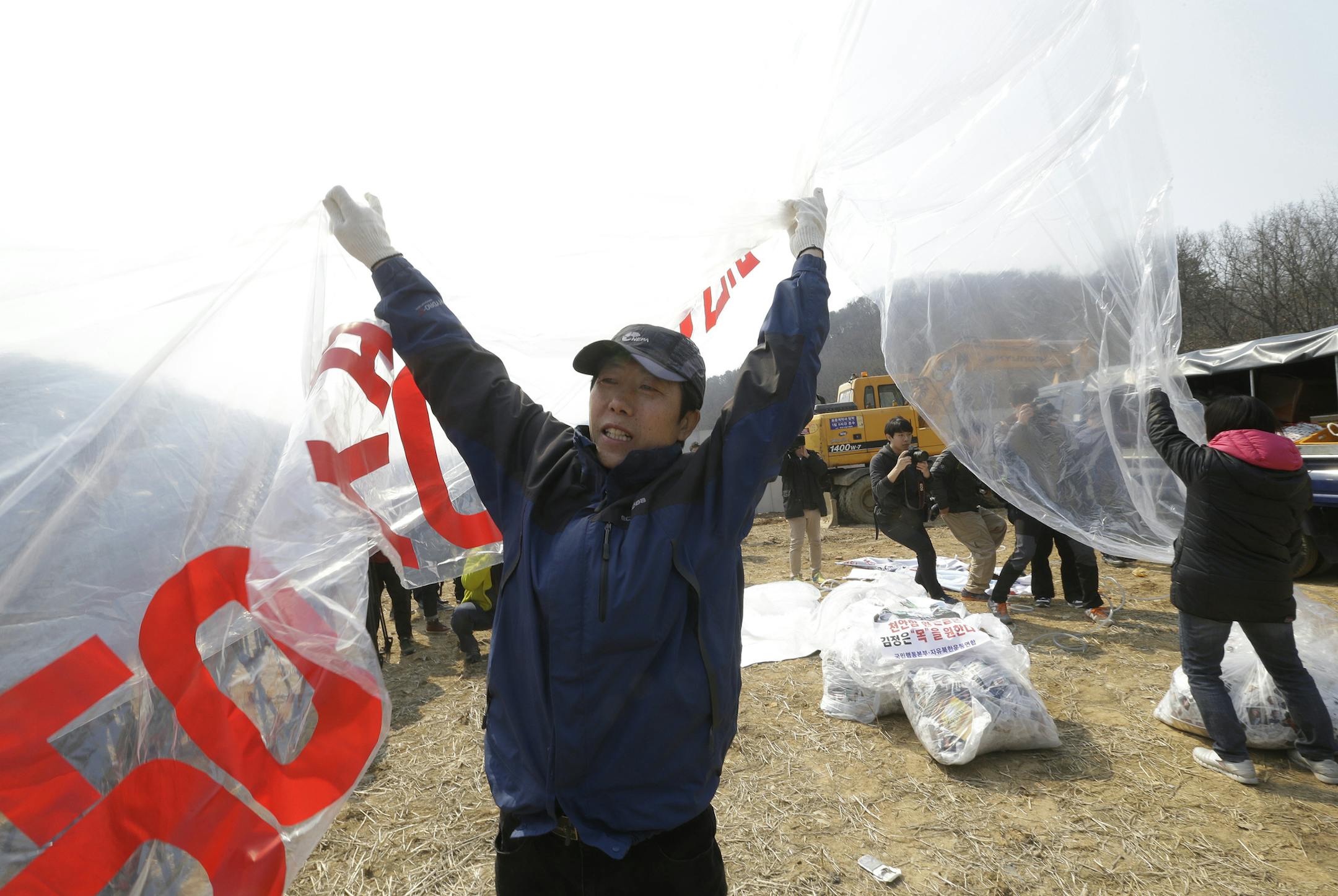North Korean defector Park Sang-hak prepares to release balloons carrying leaflets and a banner condemning North Korean leader Kim Jong Un during a rally marking the 6th anniversary of the sinking of the South Korean naval ship "Cheonan" near the border with North Korea in Paju, South Korea, Saturday, March 26, 2016. In 2010, an explosion ripped apart the 1,200-ton warship, killing 46 South Korean sailors near the maritime border with North Korea. (AP Photo/Ahn Young-joon)