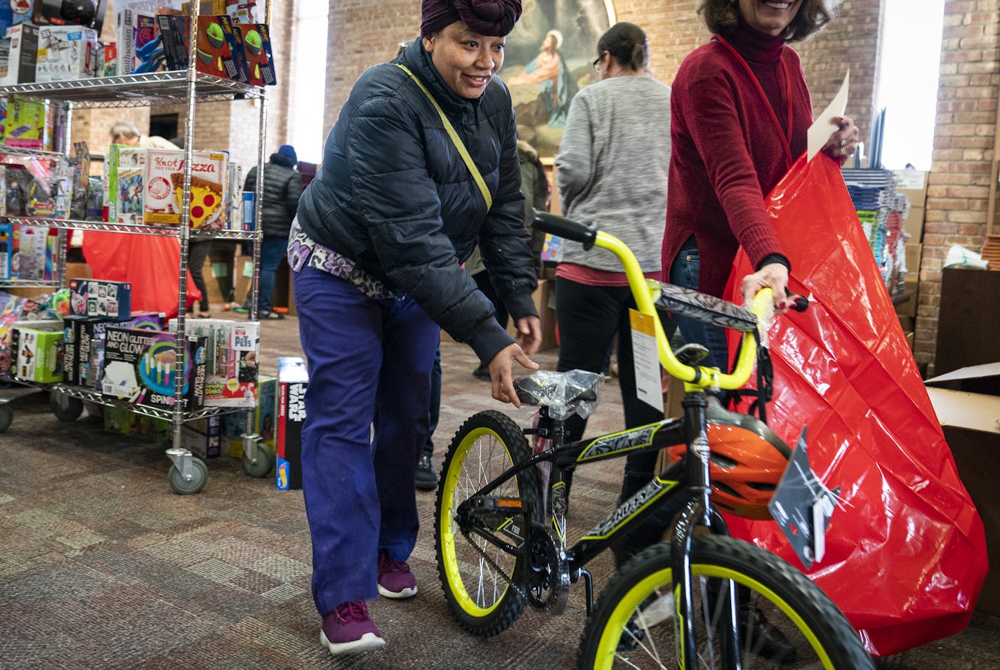 Thwanda Thomas of Minneapolis picked out a bike for her 7-year-old at the Salvation Army Toy Shop on Wednesday, Dec. 18.