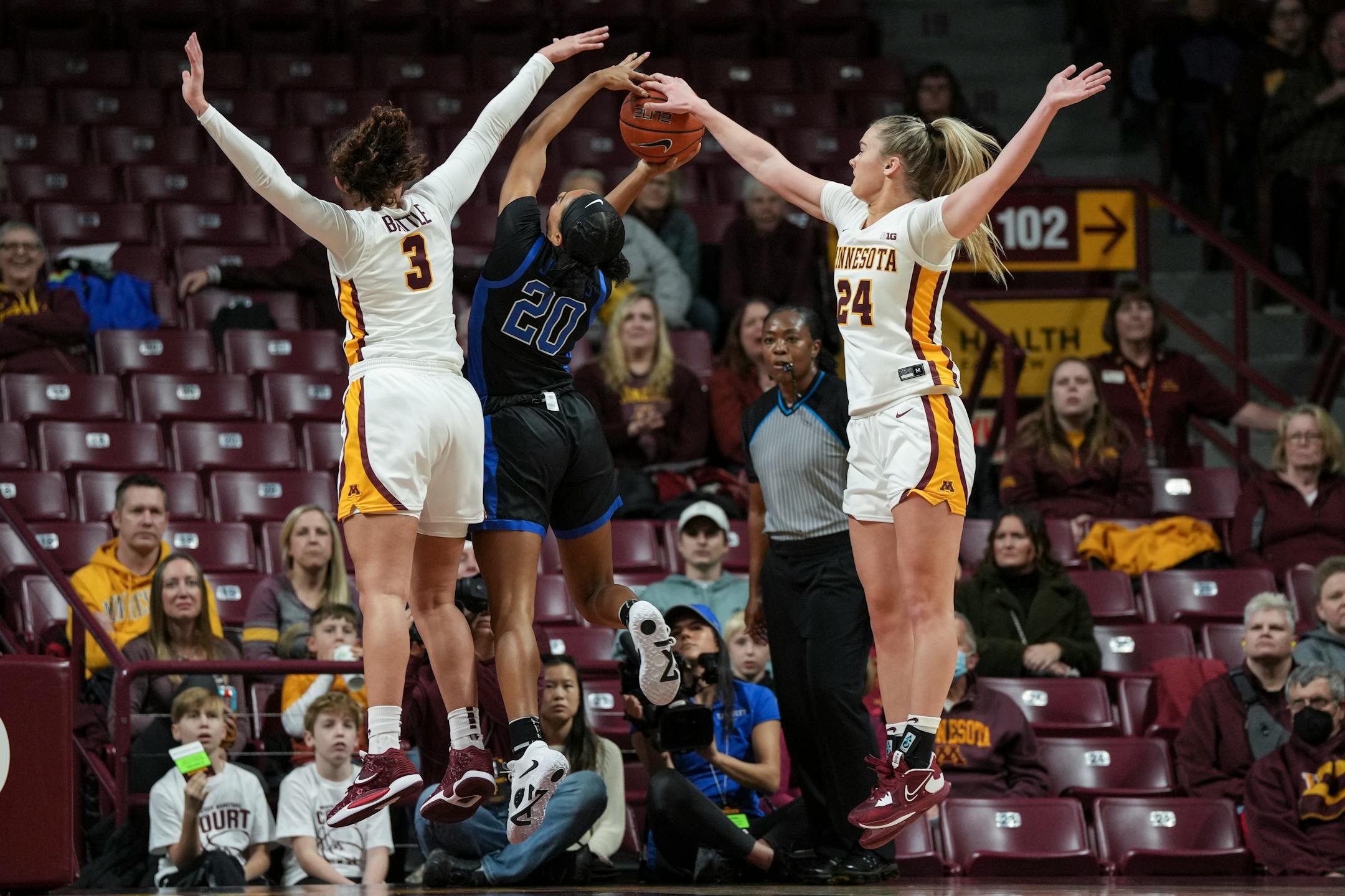 Minnesota Gophers guard Amaya Battle (3) and Minnesota Gophers forward Mallory Heyer (24) try to stop Kentucky Wildcats guard Amiya Jenkins (20) from scoring in the first half.