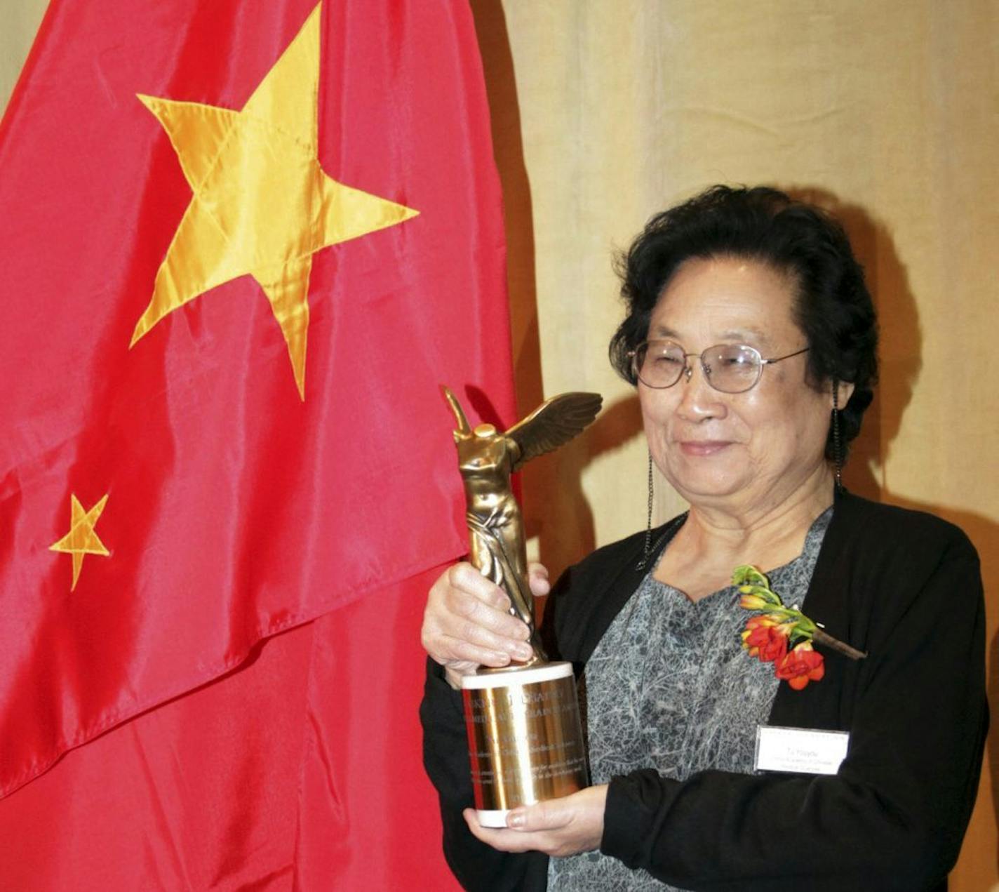 This photo taken Sept. 23, 2011 and released by Xinhua News Agency on Monday, Oct. 5, 2015 shows Chinese pharmacologist Tu Youyou posing with her trophy after winning the Lasker Award, a prestigious U.S. medical prize, in New York. Three scientists from Ireland, Japan and China won the 2015 Nobel Prize in medicine on Monday, Oct. 5, 2015 for discovering drugs against malaria and other parasitic diseases that affect hundreds of millions of people every year. Tu was awarded the prize for discoveri