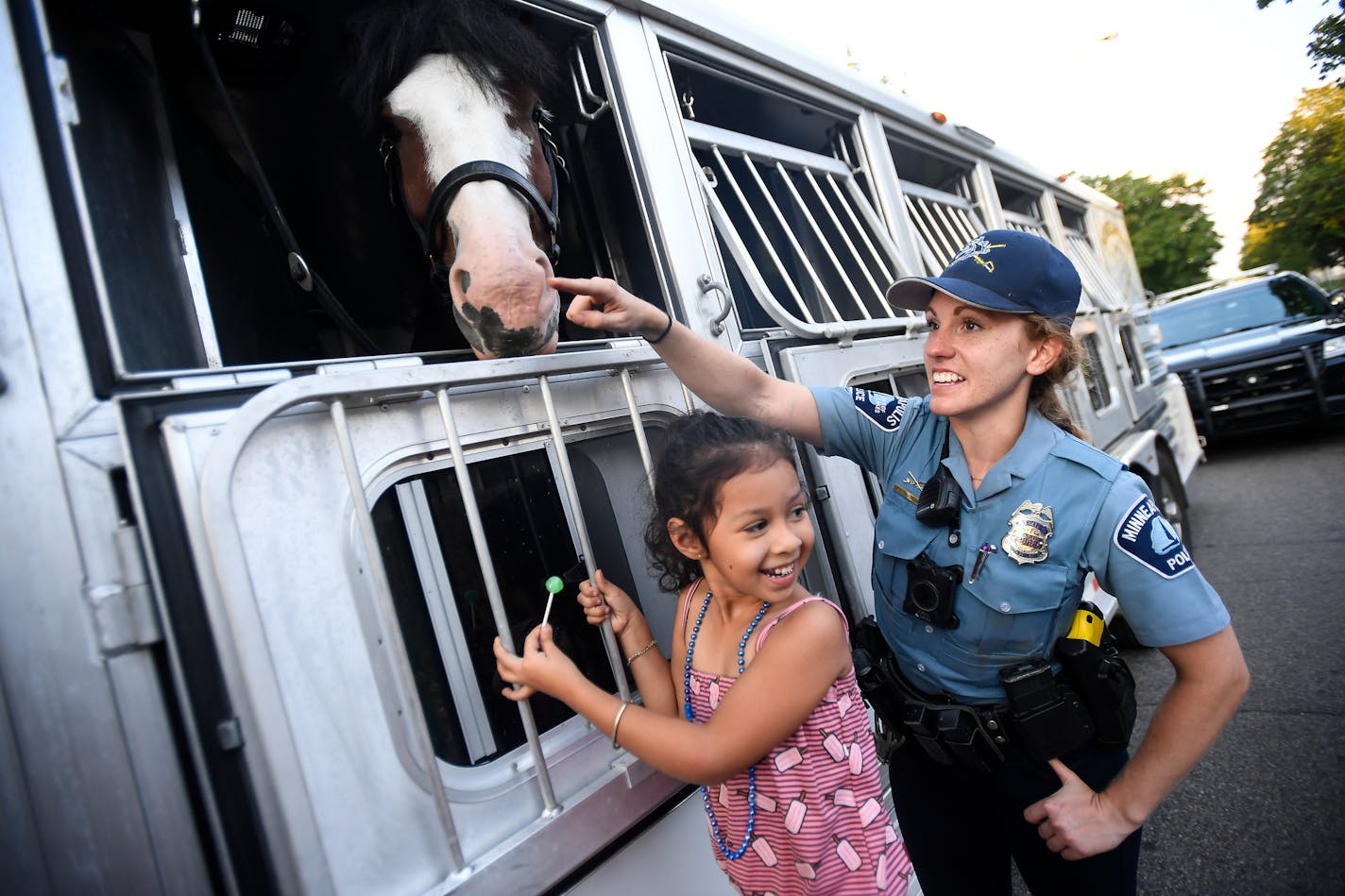 Jorllynn Buenrostro, 5, giggled after Minneapolis Police officer Erin Grabosky showed her the soft spot on her horse Trooper's snout Tuesday night during at National Night Out stop on the 4700 block of Bryant Avenue North. ] AARON LAVINSKY &#x2022; aaron.lavinsky@startribune.com Coverage of National Night Out, which is pushing record breaking numbers in the Twin Cities. The nationwide event promotes block parties as a way to connect neighbors with each other and law enforcement. We photograph th