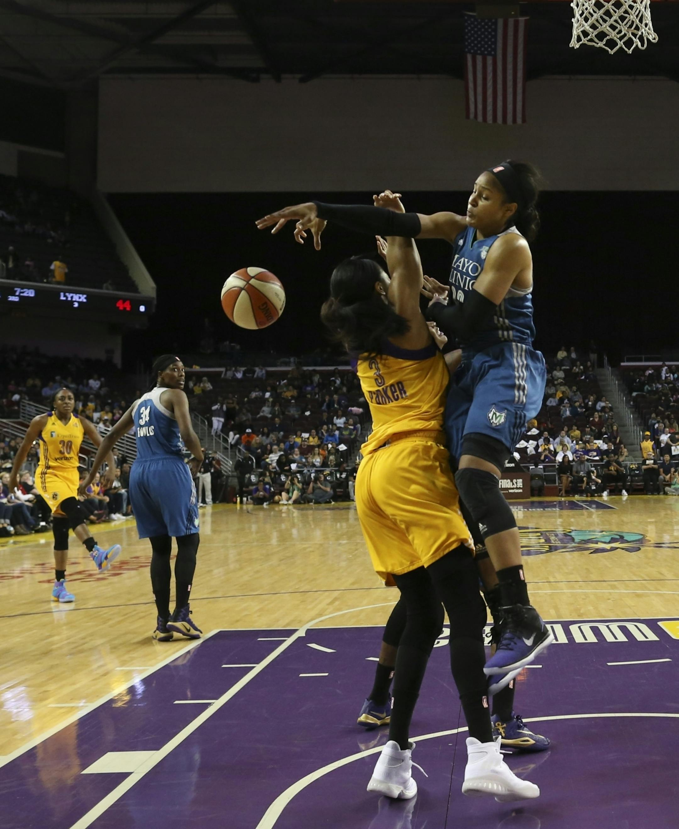 Minnesota Lynx forward Maya Moore (23) fouled Los Angeles Sparks forward Candace Parker (3) while she shot in the third quarter.