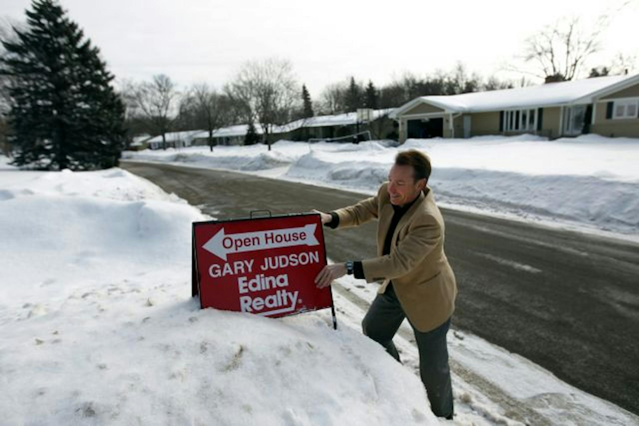 Realtor Gary Judson prepared for a recent open house. He says it's been challenging to get established in the business with so much competition for buyers.