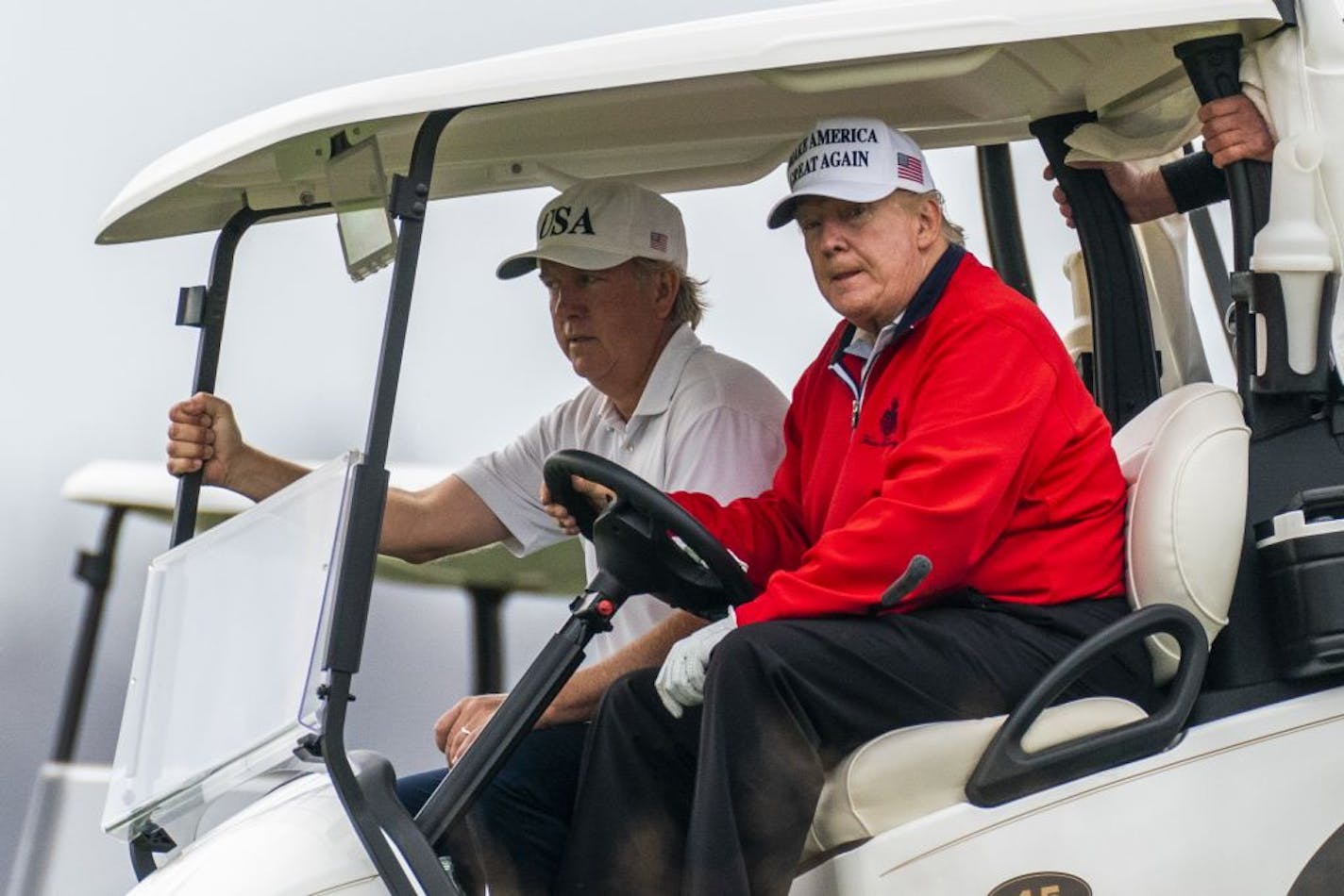 President Donald Trump, drives his golf cart as he plays golf at the Trump National Golf Club in Sterling, Va., Saturday, Nov. 21, 2020.