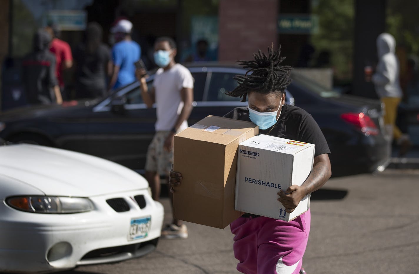 A man ran with box of goods taken from a store along University Avenue in St Paul .