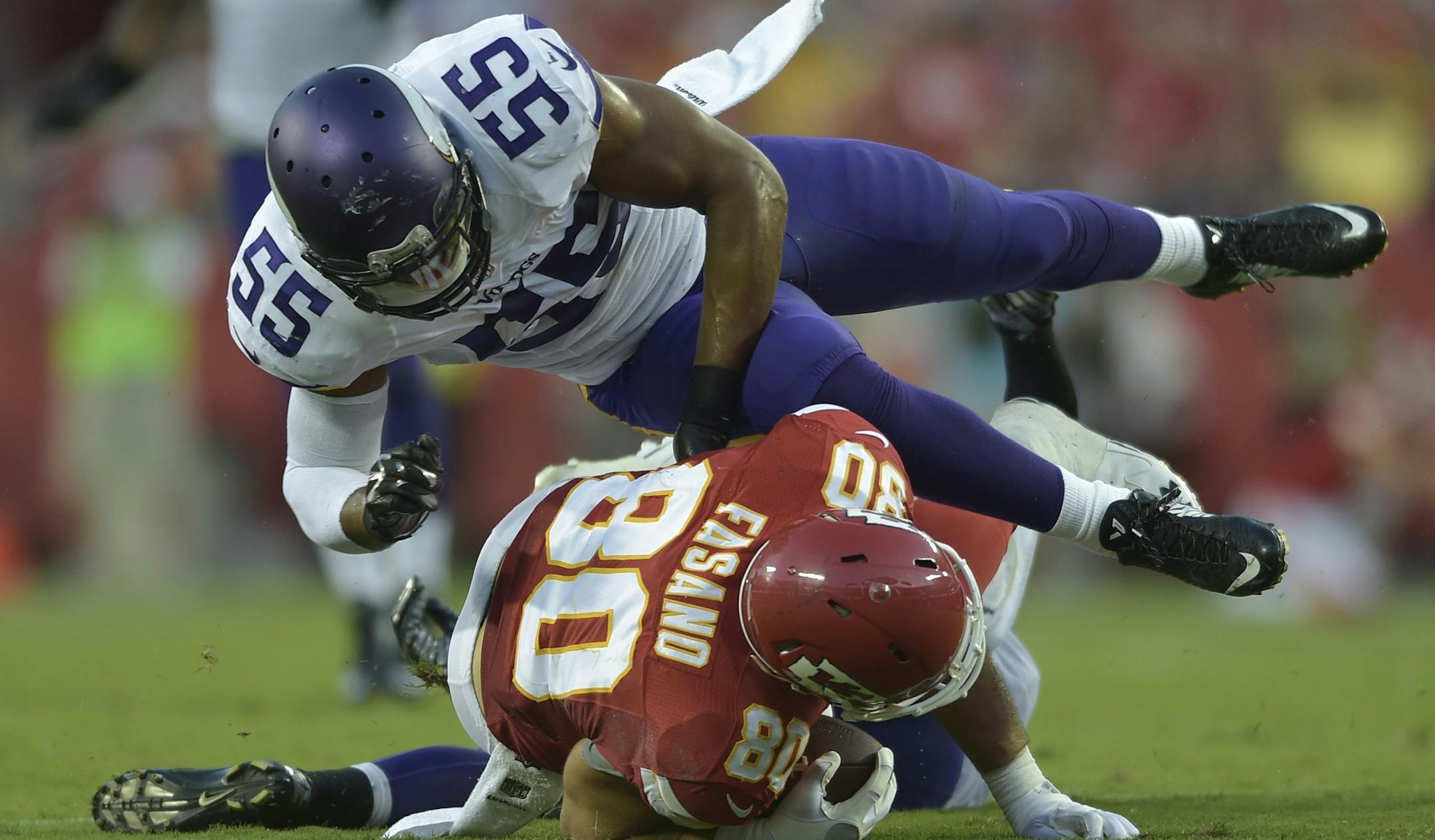 Minnesota Vikings outside linebacker Anthony Barr (55) flies over Kansas City Chiefs tight end Anthony Fasano (80) during an NFL preseason football game between the Kansas City Chiefs and Minnesota Vikings in Kansas City, Mo., Saturday, Aug. 23, 2014. (AP Photo/Reed Hoffmann) ORG XMIT: OTKRH