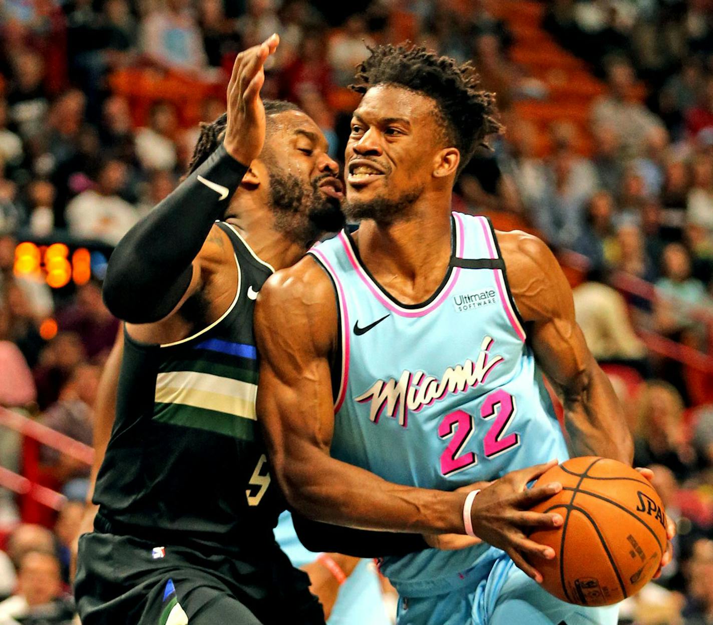 The Miami Heat's Jimmy Butler (22) drives against the Milwaukee Bucks' Wesley Matthews (9) at the AmericanAirlines Arena in Miami on March 2, 2020. (Charles Trainor Jr./Miami Herald/TNS) ORG XMIT: 1626598