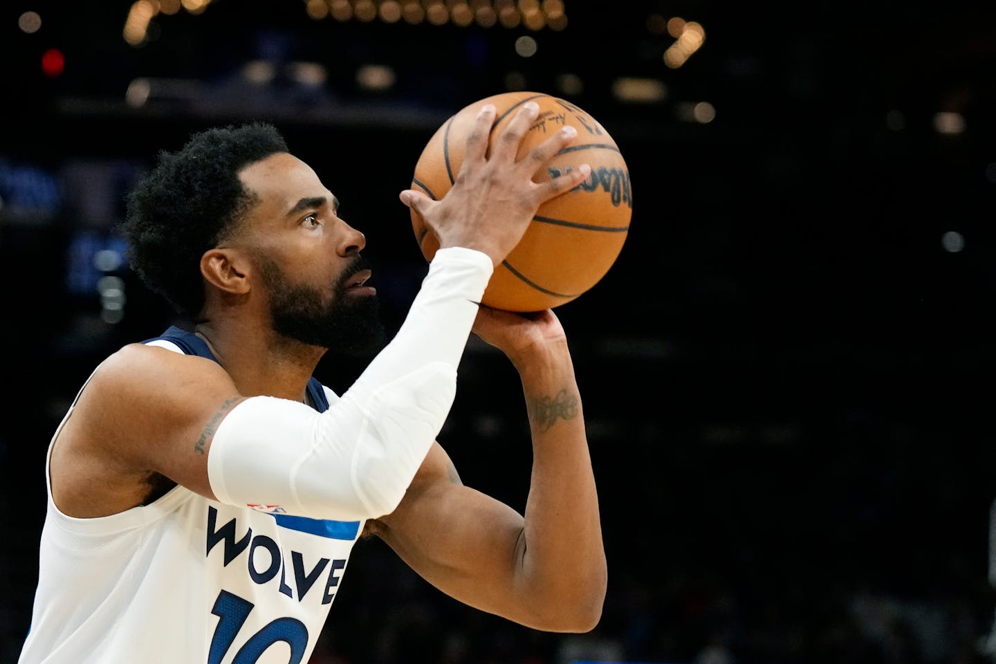 Minnesota Timberwolves guard Mike Conley gets ready to shoot a jumper against the Phoenix Suns during the first half of an NBA basketball game Wednesday, March 29, 2023, in Phoenix. (AP Photo/Ross D. Franklin)