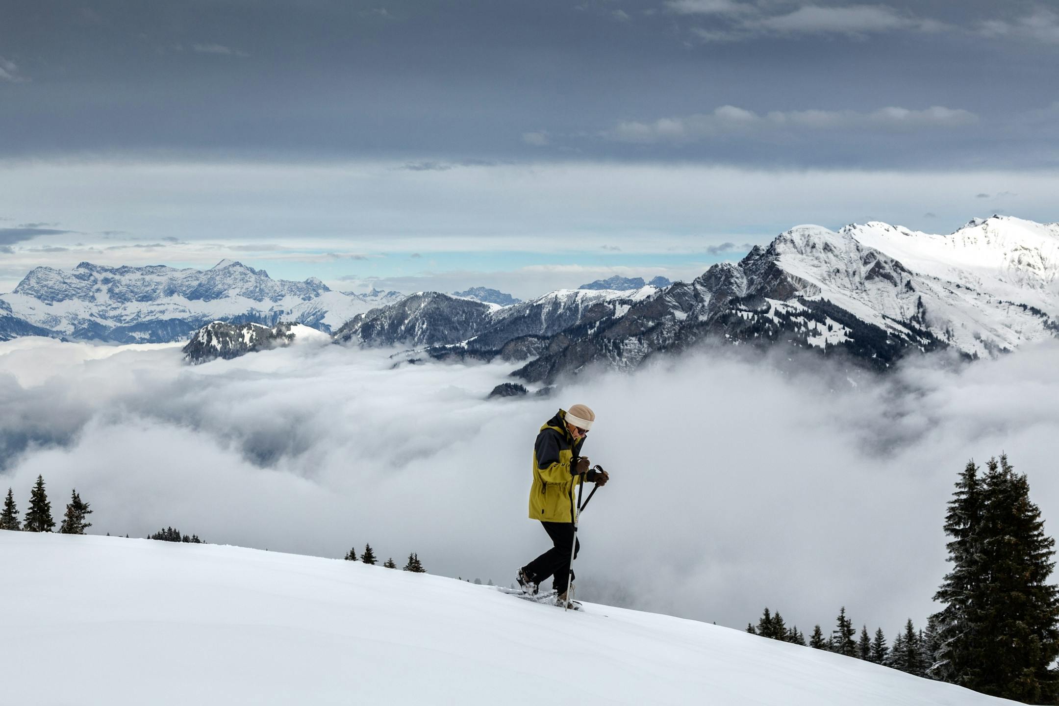 A woman makes her way through the snow at Malixer mountain above the Rhine valley near Chur, Switzerland Thursday Nov. 21, 2013. Weather forecasts predict changeable weather and cold temperatures for Switzerland.