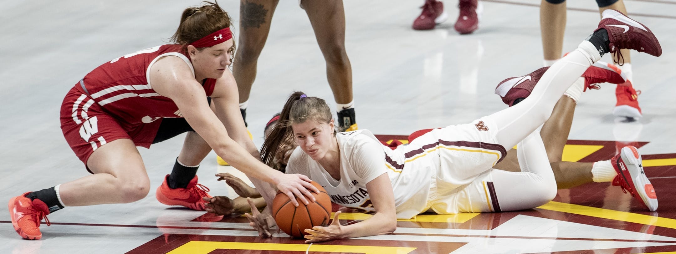 Kara Crowley (30) of Wisconsin and Masha Adashchyk (23) of Minnesota fought for a loose ball in the fourth quarter.
