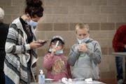 Tammi Bertram and her children Kristalyn, 6, center, and Bentley, 9, took a COVID-19 test at the new saliva testing center in Inver Grove Heights, on 