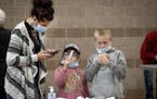Tammi Bertram and her children Kristalyn, 6, center, and Bentley, 9, took a COVID-19 test at the new saliva testing center in Inver Grove Heights, on 