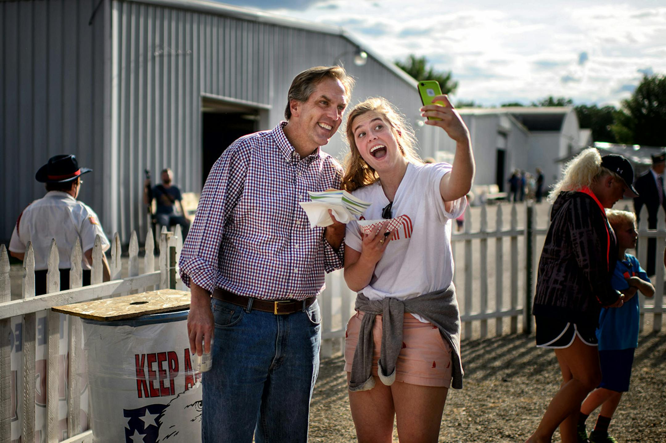 Molly McFadden grabs selfie with her dad Mike McFadden after they bought pulled beef and sauerkraut sandwiches at the American Legion sandwich and beer area of the American Legion at the Waseca County Free Fair, Wednesday, July 16, 2014. Mike McFadden bought a Diet Coke. ] GLEN STUBBE * gstubbe@startribune.com