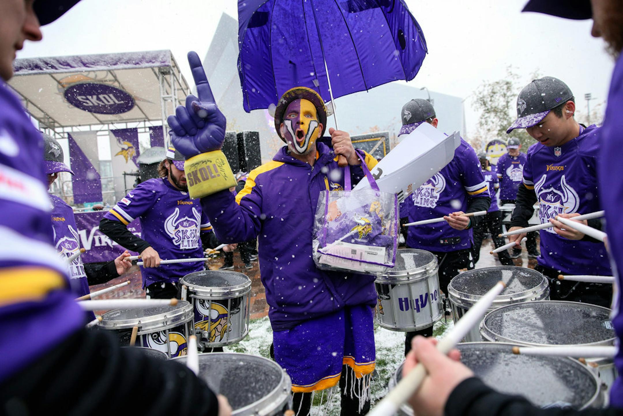 Vikings fan Rick Childs from Elysian, Minn., was greeted with a snow shower and the Vikings Skol Drum Line before the game at U.S. Bank Stadium Sunday morning.