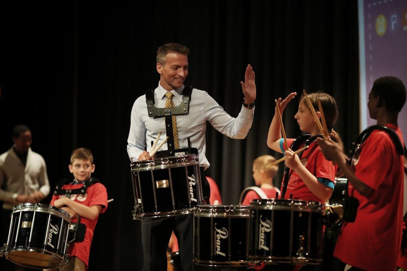 Minneapolis school Superintendent Ed Graff, left high-fived Jonah Gunderman a members of the Gems and Gise drum group after giving his state of the schools address Monday August 20, 2018 at North Community High School in Minneapolis, MN.