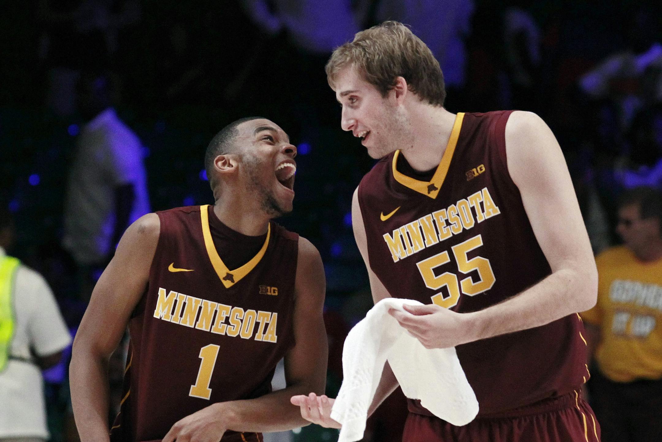 Minnesota's Andre Hollins (1) and Elliott Eliason (55) celebrate after defeating Stanford 66-63 in an NCAA college basketball game at the Battle 4 Atlantis tournament Saturday, Nov. 24, 2012, in Paradise Island, Bahamas.
