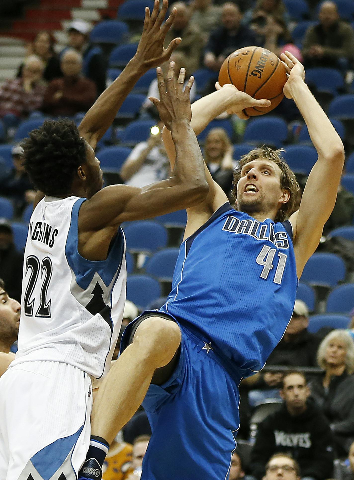 Dallas Mavericks forward Dirk Nowitzki (41) falls back for a shot against Minnesota Timberwolves forward Andrew Wiggins (22) in the second half of an NBA basketball game, Sunday, Jan. 10, 2016, in Minneapolis. The Mavericks won 93-87. (AP Photo/Stacy Bengs)