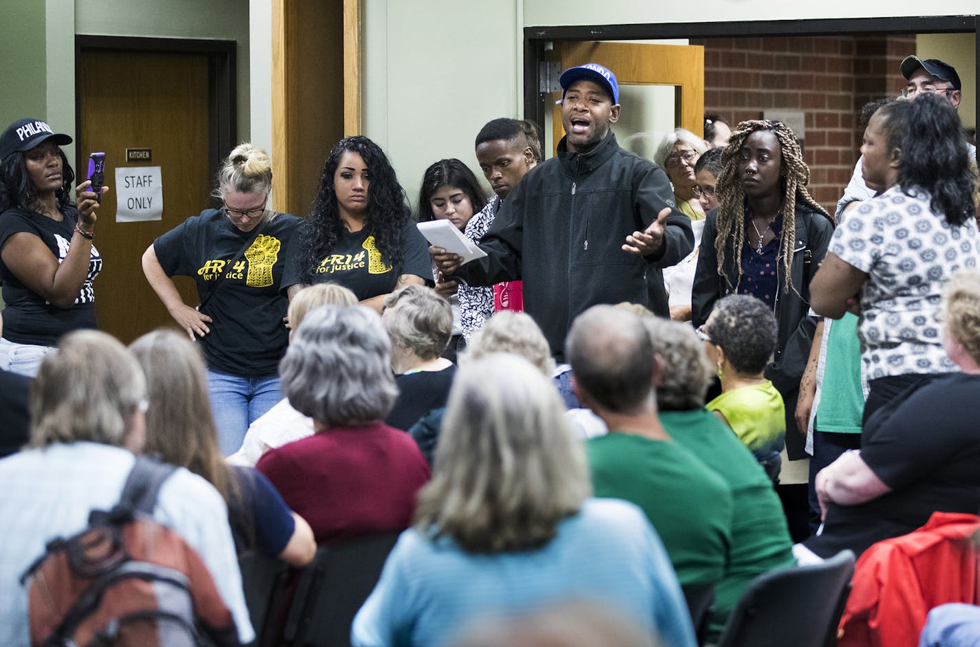 John Thompson, center, participates in a discussion that evolved in the council chambers after the city council took a recess. The conversation was about the experience of being black and white privilege. "I am Philando," said Thompson. ] (Leila Navidi/Star Tribune) leila.navidi@startribune.com BACKGROUND INFORMATION: Falcon Heights City Council reviews policing policies at a City Council workshop meeting on Wednesday, September 7, 2016. Protesters for Philando Castile shut down the meeting by y