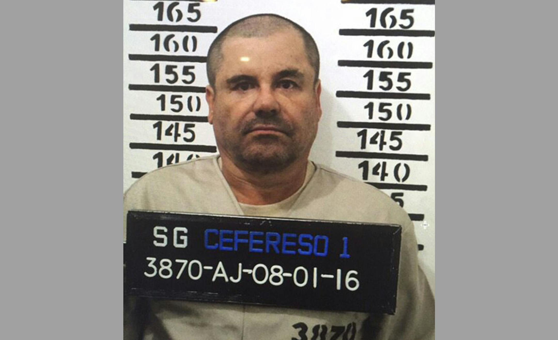 In this Jan. 8, 2016 image released by Mexico's federal government, Mexico's most wanted drug lord, Joaquin "El Chapo" Guzman, stands for his prison mug shot, with the inmate number 3870 at the Altiplano maximum security federal prison in Almoloya, Mexico. Mexico has begun the process of extraditing Guzman to the United States, where he faces drug-trafficking charges, but that could take "a year or longer" because of legal challenges, said the head of Mexico's extradition office, Manuel Merino.