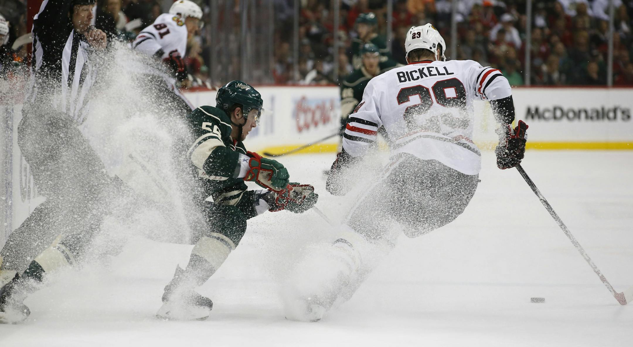 Minnesota Wild left wing Erik Haula (56) and Chicago Blackhawks left wing Bryan Bickell (29) sprayed ice shavings as they head after the puck during the first period. ] CARLOS GONZALEZ cgonzalez@startribune.com - May 13, 2014, St. Paul, Minn., Xcel Energy Center, NHL, Minnesota Wild vs. Chicago Blackhawks, Stanley Cup Playoffs Round 2, Game 6