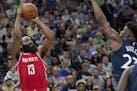 Houston Rockets' James Harden (13) is defended by Timberwolves' Jimmy Butler (23) in the third quarter in Game 4 of their series Monday, April 23, 201
