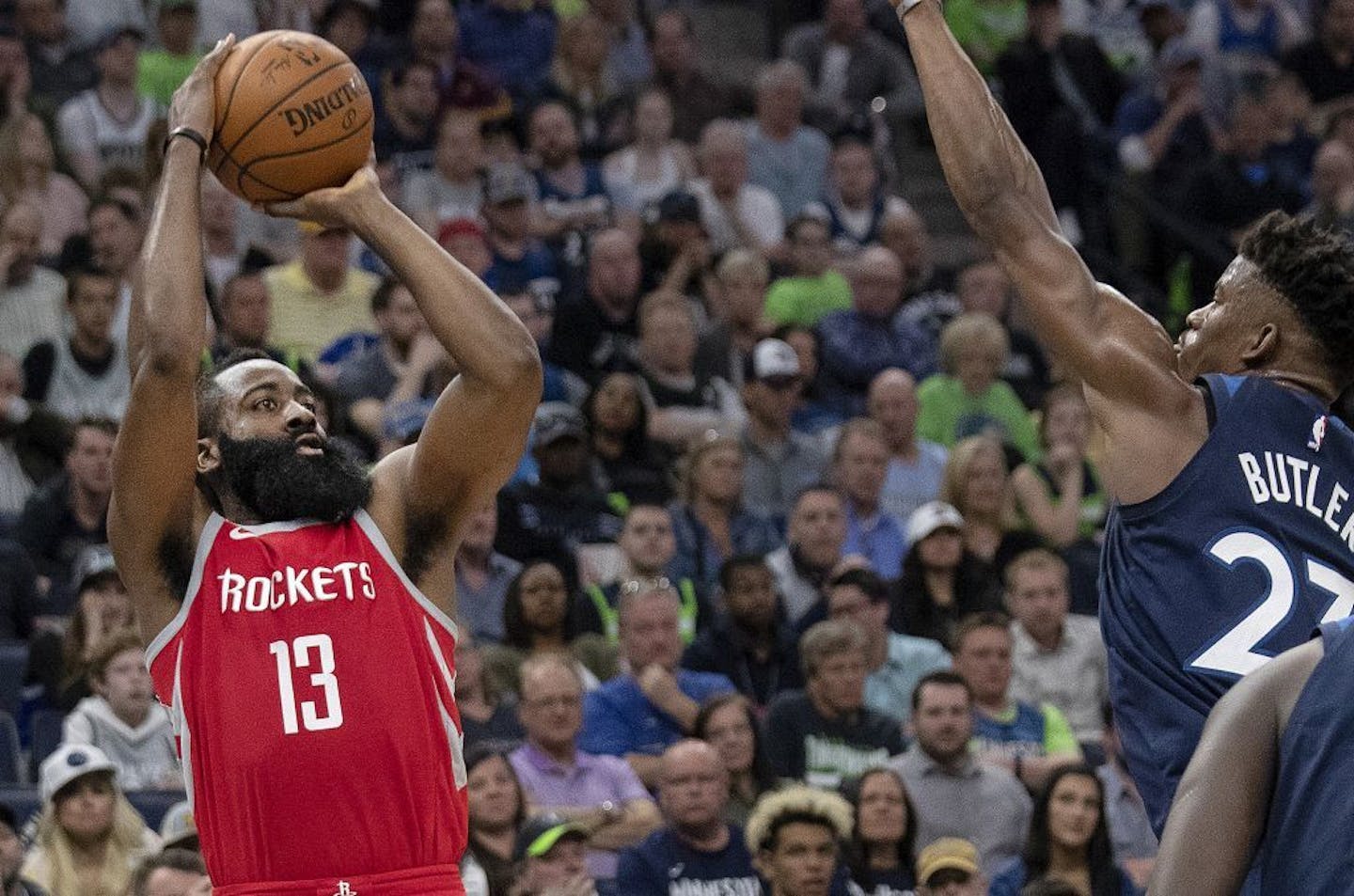 Houston Rockets' James Harden (13) is defended by Timberwolves' Jimmy Butler (23) in the third quarter in Game 4 of their series Monday, April 23, 2018 at the Target Center in Minneapolis, Minn. The Rockets won,