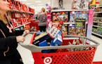 Shoppers browse the aisles during a Black Friday sale at a Target store, Friday, Nov. 23, 2018, in Newport, Ky.