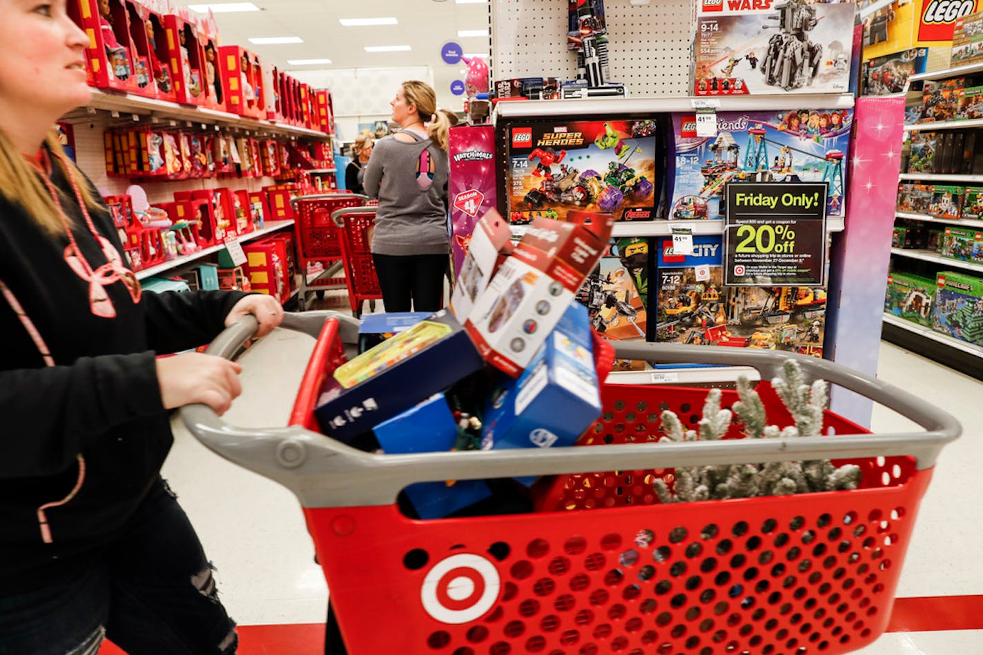 Shoppers browse the aisles during a Black Friday sale at a Target store, Friday, Nov. 23, 2018, in Newport, Ky.