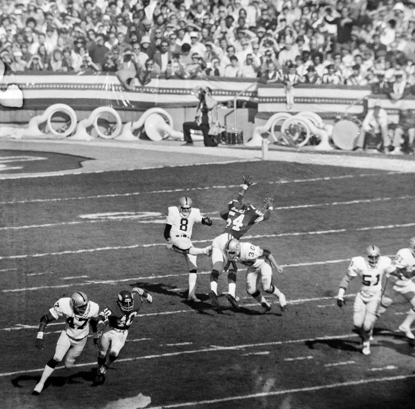 Linebacker Fred McNeill (dark jersey) of the Minnesota Vikings blocks a punt by Oakland's Ray Guy in the first quarter of Super Bowl XI in Pasadena, Calif., Jan. 9, 1977. (AP Photo)