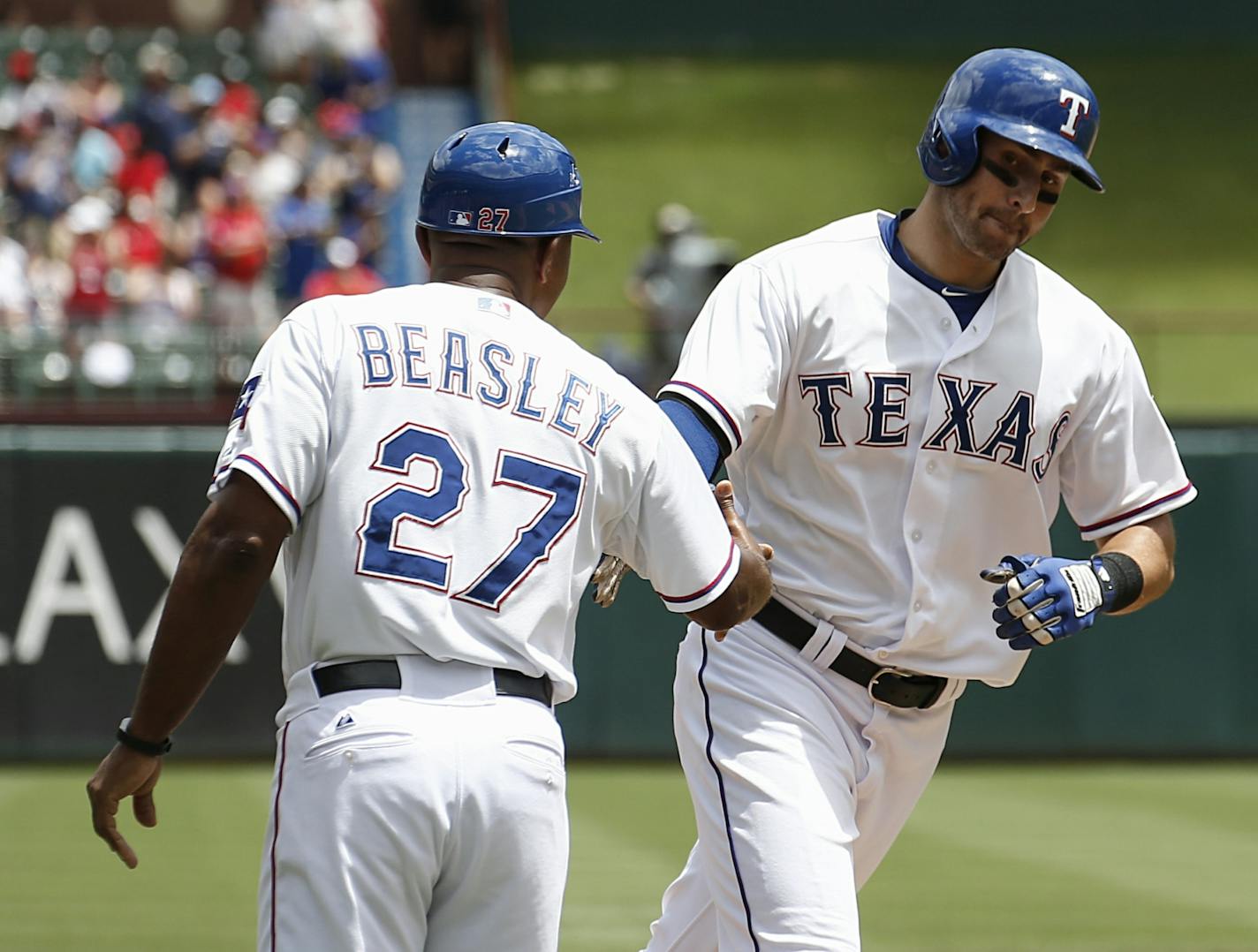 Texas Rangers' Joey Gallo is congratulated by third base coach Tony Beasley (27) for his home run against the Minnesota Twins during the second inning of a baseball game, Sunday, June 14, 2015, in Arlington, Texas.