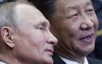 CORRECTING SLUG TO RUSSIA CHINA - Russian President Vladimir Putin, left, and Chinese President Xi Jinping visit the Ocean Russian children recreation
