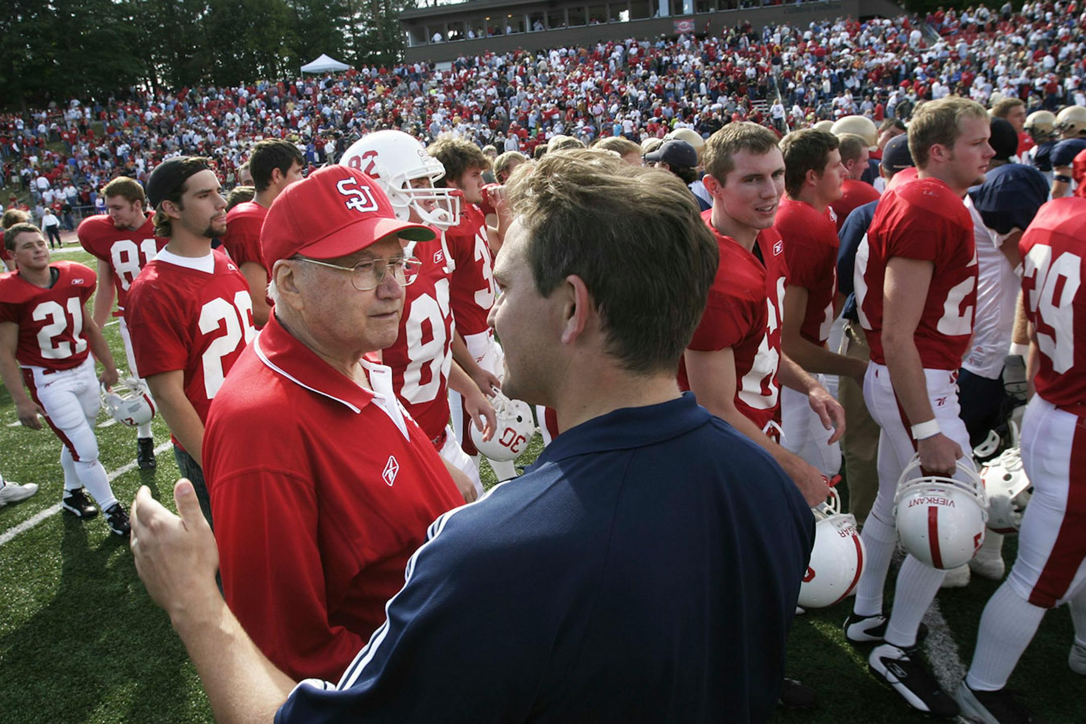 After the 2003 home opener against Wis.-Eau Claire, St. John's football coach John Gagliardi was congratulated by Wis.-Eau Claire coach Todd Hoffner.