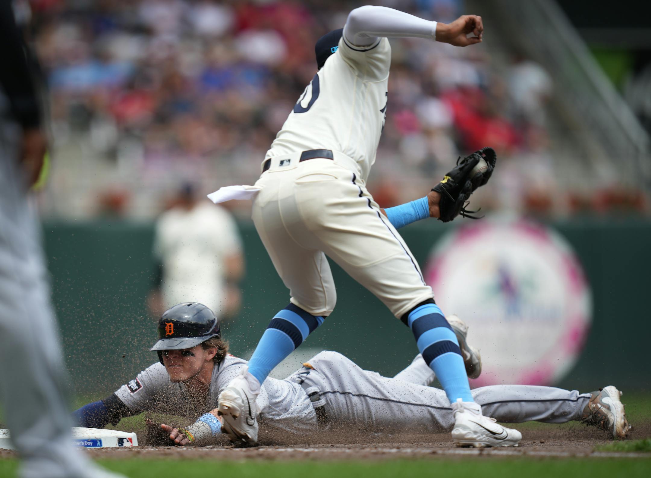 Detroit Tigers third baseman Nick Maton (9) slides into third base as Minnesota Twins third baseman Royce Lewis (23) is late with the tag.