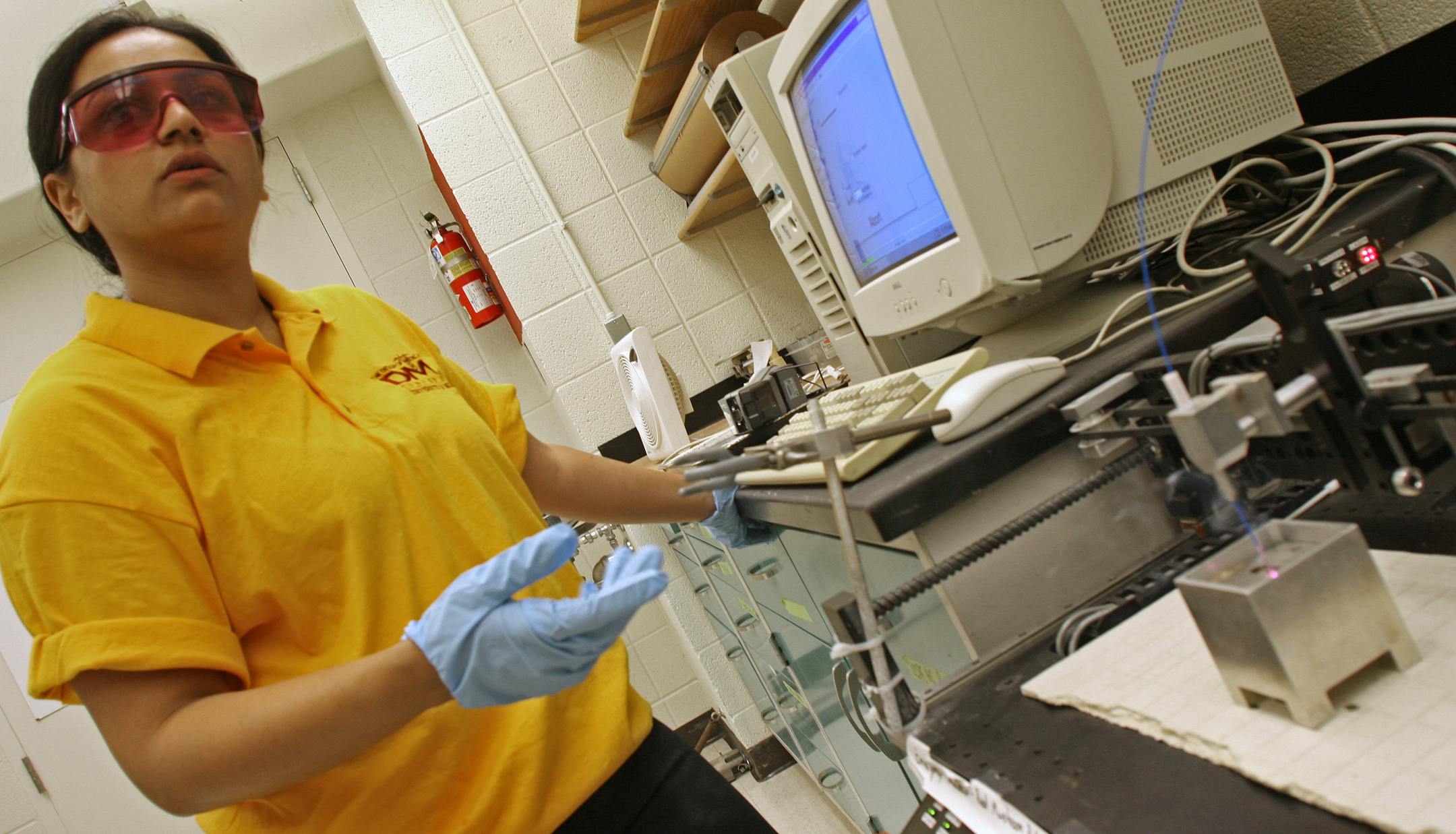 (left to right) University of Minnesota Mechanical Engineering PHD student Deepa D. (cq) demonstrated the use of a laser on tissue samples. The new U medical device laboratory is working on joining lasers with MRI machines to one day perform breast surgery during MRI scans using robotic devices. The University of Minnesota Medical Device Lab features high-tech equipment that allows doctors to view live surgeries in 3D with the da Vinci S. Surgical System, computer aided design equipment and mech