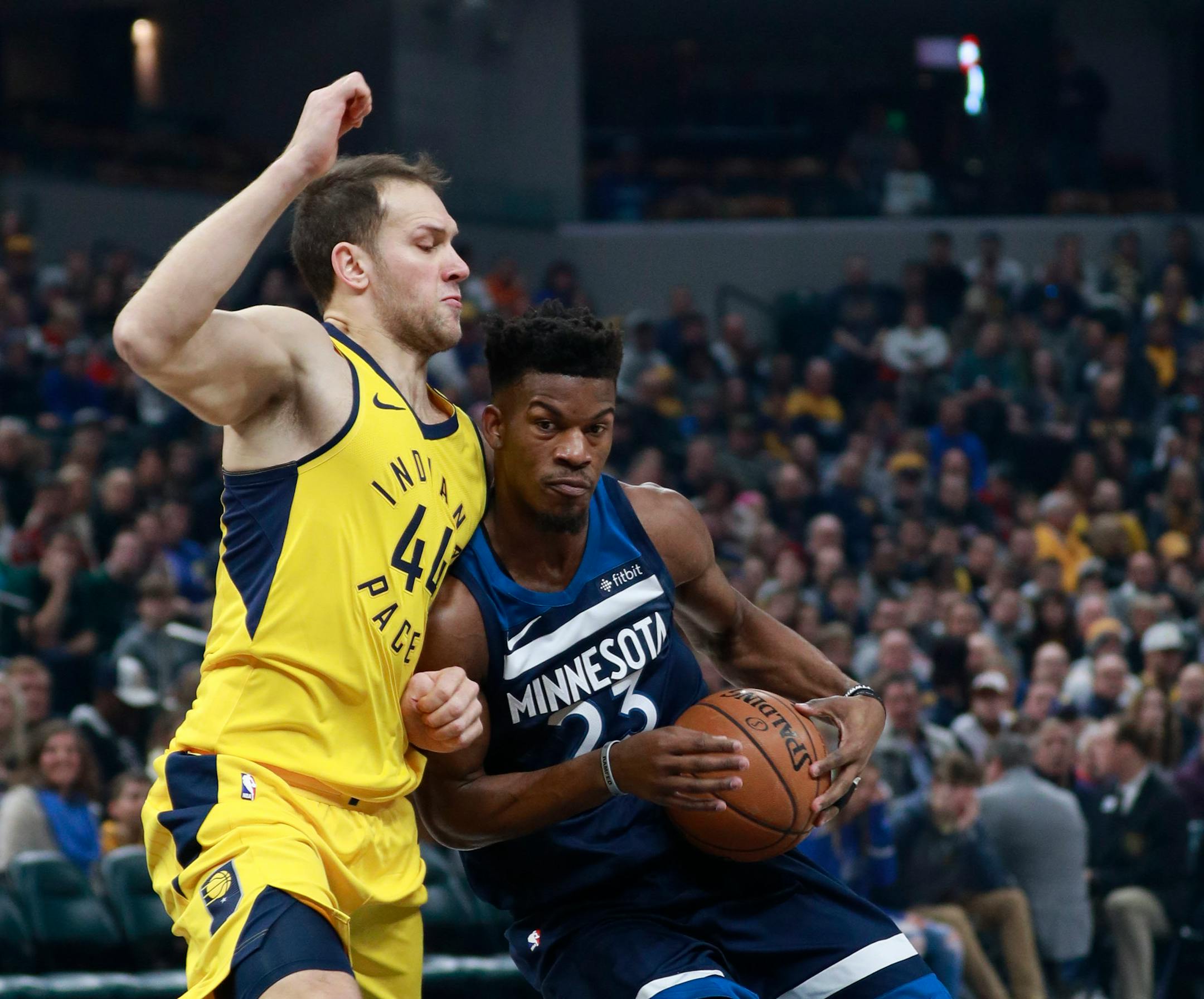 Minnesota Timberwolves guard Jimmy Butler, right, drives with the basketball defended by Indiana Pacers forward Bojan Bogdanovic in the first half of an NBA basketball game, Sunday, Dec. 31, 2017, in Indianapolis. (AP Photo/R Brent Smith)