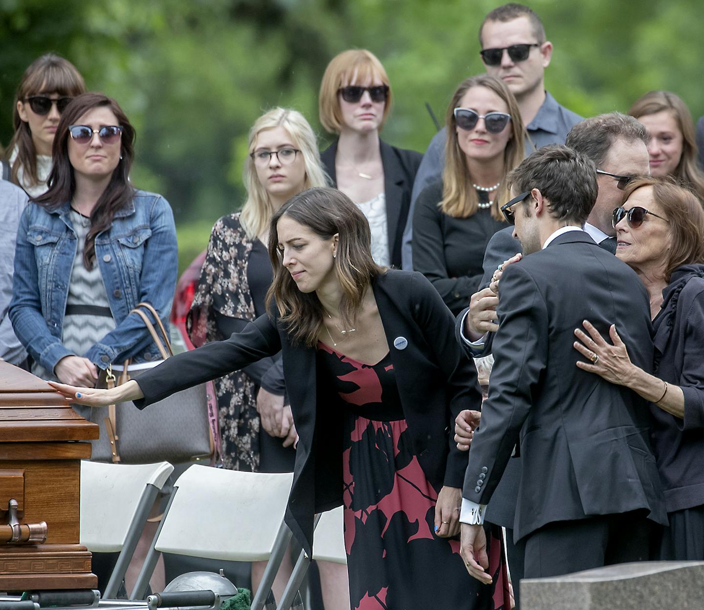 Gabriele Grunewald's sister Abigail Anderson, along with family and friends, bid farewell to the professional runner at the burial at Hillside Cemetery,