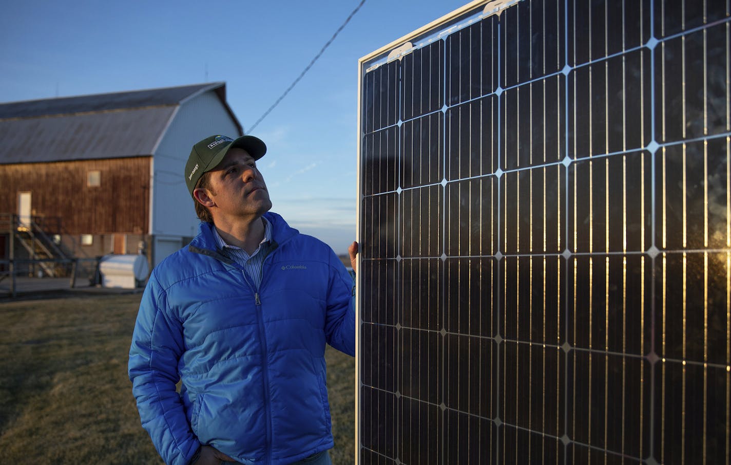 In this Dec. 18, 2018 photo, Invenergy's renewable energy manager Dan Litchfield shows a single solar panel outside of the company's office in Cobb, Wis. These panels would become part of a 3,500-acre solar project. The proposed 3,500-acre solar farm in Iowa County, Wisconsin, has pitted farmers against each other and split renewable energy supporters. (Emily Hamer/Wisconsin Center for Investigative Journalism via AP) ORG XMIT: MER7a50c331e411982c3ec932cc9b504