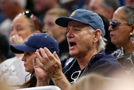Actor and comedian Bill Murray cheers as he watches the first half of the first round of the NCAA college basketball tournament between Maryland and X