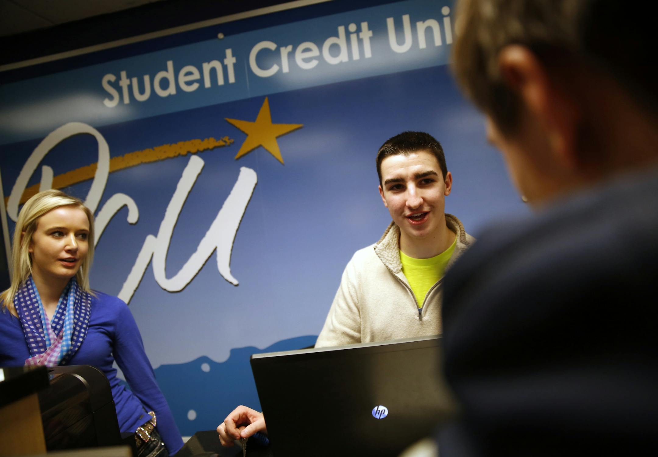 Postal Credit Union has opened a credit union for students at Tartan High School, run by three students including Geneva Eilertson,left, and Marc Buchmayer, right, who was trying to convince Elijah McGeehan to open an account. What's the most popular feature? The 2 percent CD it offers -- that's generating a lot of buzz, but not among the students, the parents.. ]rtsong-taatarii@startribune.com