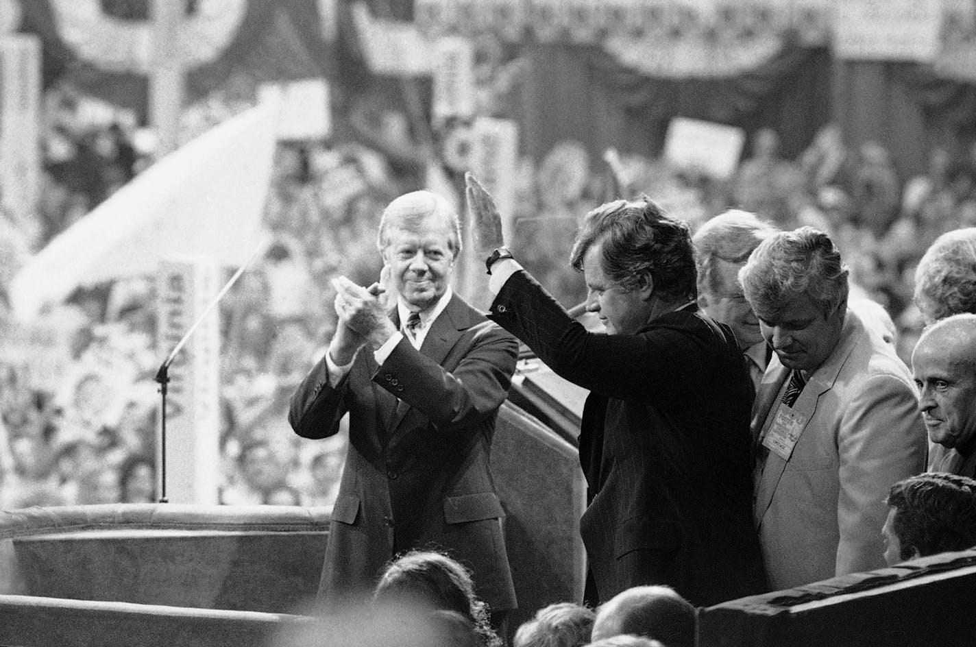 President Jimmy Carter applauds as Sen. Edward Kennedy waves to cheering crowds of the Democratic National Convention in New York's Madison Square Garden, Aug. 14, 1980. (AP Photo/Bob Daugherty) ORG XMIT: APHS246444