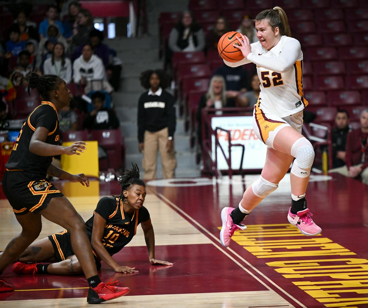Minnesota Gophers center Sophie Hart (52) jumps to keep the ball in bounds in the second quarter against the Grambling Lady Tigers Wednesday at Willia